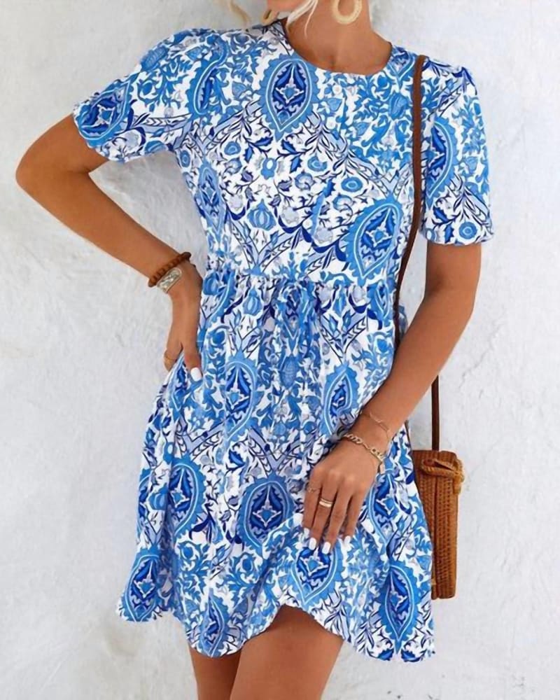 Front of a model wearing a size XLARGE Alicia Printed Short Sleeve Dress in Blue in Blue by Annva Fashion. | dia_product_style_image_id:339124